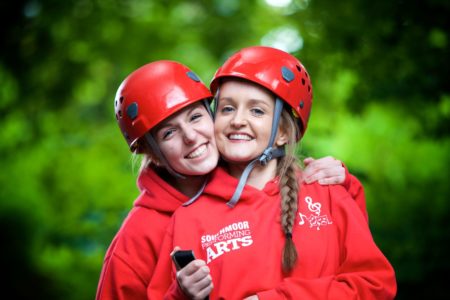 Two secondary pupils huddle together to celebrate their success