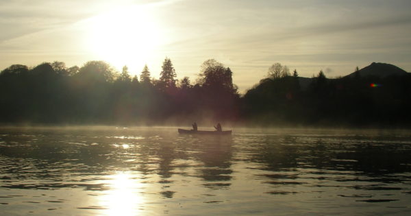 Canoeing on Derwent Water during a misty sunset 