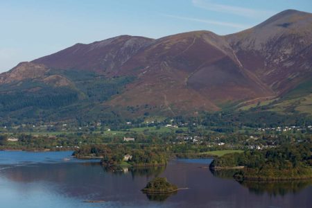 Arial view of Derwent Water and Skiddaw on a blue sky day 