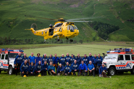Cockermouth Mountain Rescue team photo with RAF Seaking hovering above 
