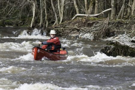 Matt open canoeing on the River Esk's white water rapids